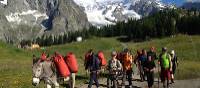 Families walking with donkeys beneath the lofty heights of Mont Blanc | Kate Baker