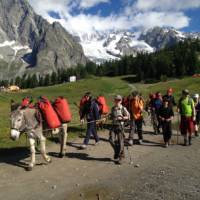 Families walking with donkeys beneath the lofty heights of Mont Blanc | Kate Baker