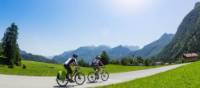 Cycling towards crisp mountain skyline