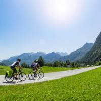 Cycling towards crisp mountain skyline