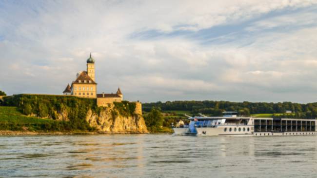 Barge crossing by Schonbuhel Castle on the Danube river