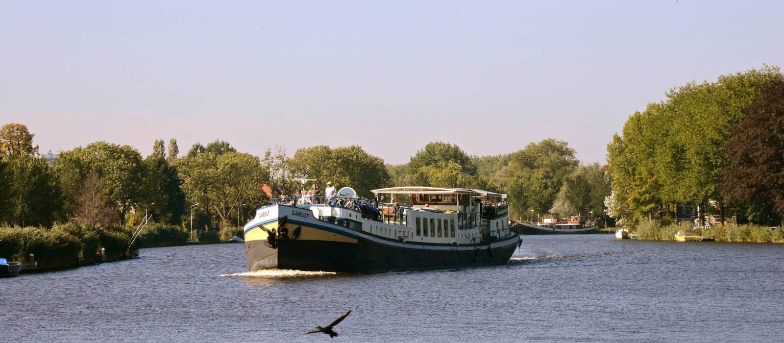 The MS Gandalf sailing the waterways past scenic landscapes