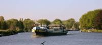 The MS Gandalf sailing the waterways past scenic landscapes