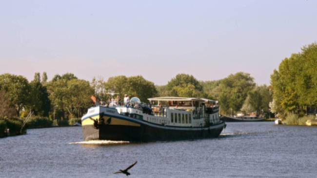 The MS Gandalf sailing the waterways past scenic landscapes