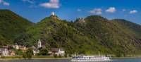 MS Olympia sails past a castle