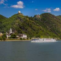 MS Olympia sails past a castle