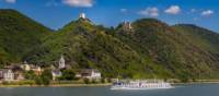 MS Olympia sails past a castle