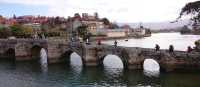 Pilgrims crossing a bridge along the Portuguese Way