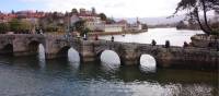 Pilgrims crossing a bridge along the Portuguese Way