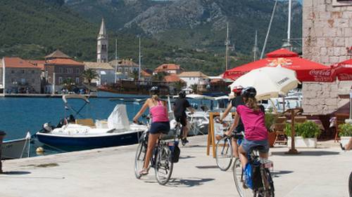 Children cycling into the town of Jelsa on the island of Hvar