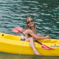 Child kayaking off the boat in the Mediterranean | Ross Baker