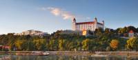 Bratislava castle with reflection in river Danube