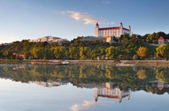 Bratislava castle with reflection in river Danube