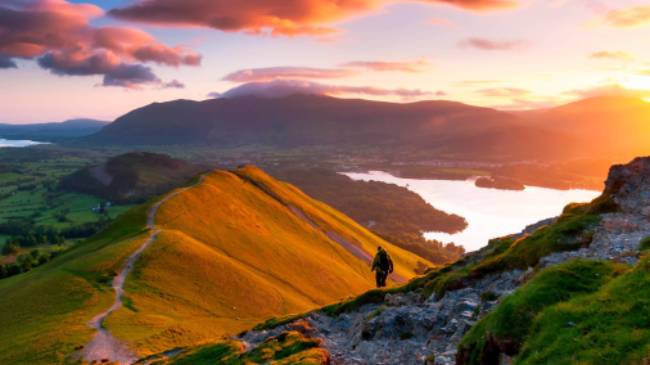 A hiker admiring the breathtaking views along the Cumbria Way. | John Finney