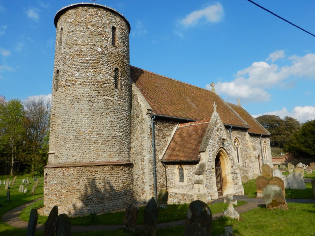 Norfolk Coast Path passes a flint round-tower church and churchyard |  Peter Wells