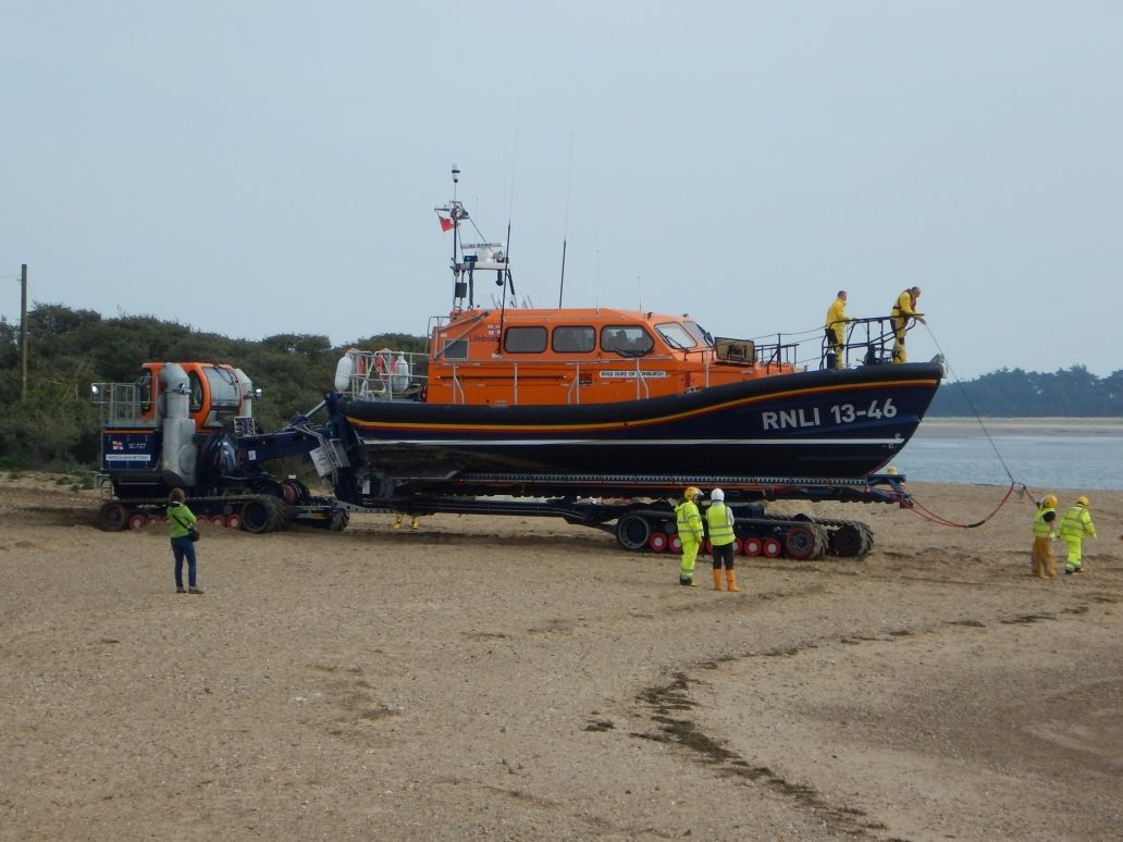 Norfolk coast lifeboat on a trailer with crew preparing on a sandy beach |  Peter Wells
