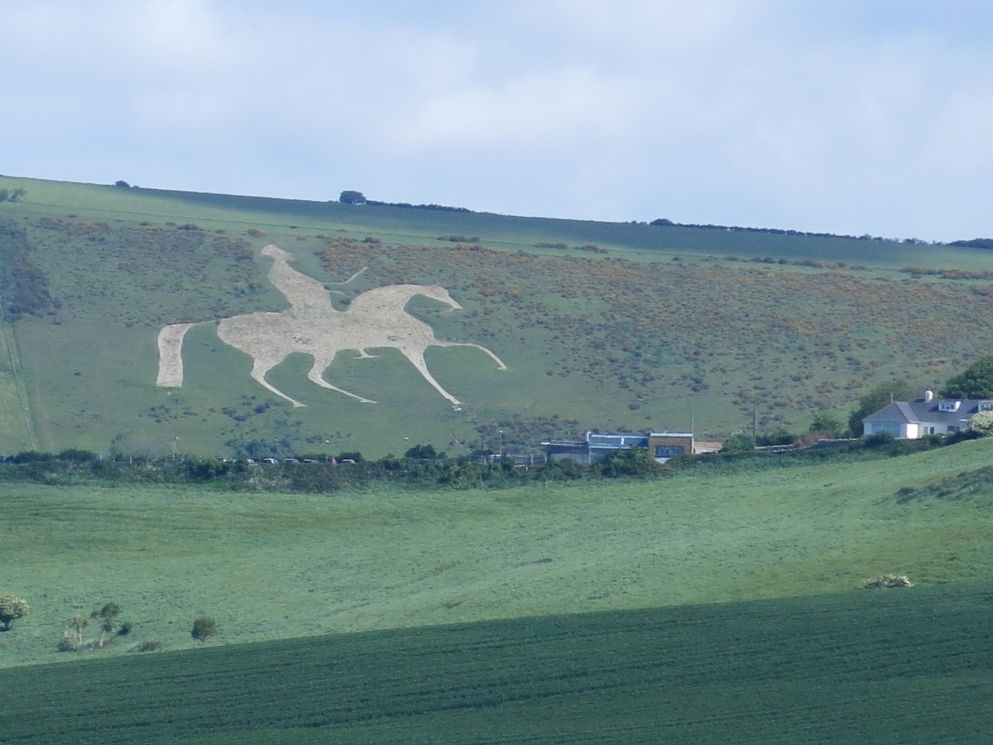 South West Coast Path walking route passes a chalk hill figure on green hills |  Peter Wells
