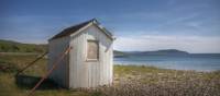 An old beach hut looking out to the ocean in Arran