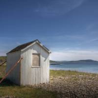 An old beach hut looking out to the ocean in Arran