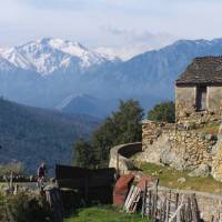 Cyclist travelling through a village, Corsica