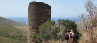 Hikers pass a Hellenistic Tower on the Andros Trail Self Guided Walk