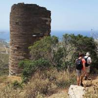 Hikers pass a Hellenistic Tower on the Andros Trail Self Guided Walk