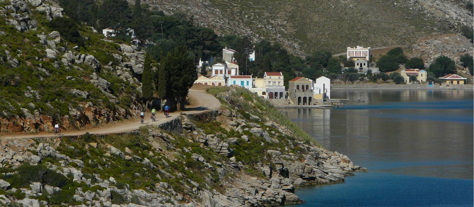 Cyclists near to the delightful town of Symi, Greece