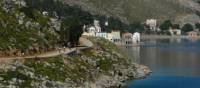 Cyclists near to the delightful town of Symi, Greece