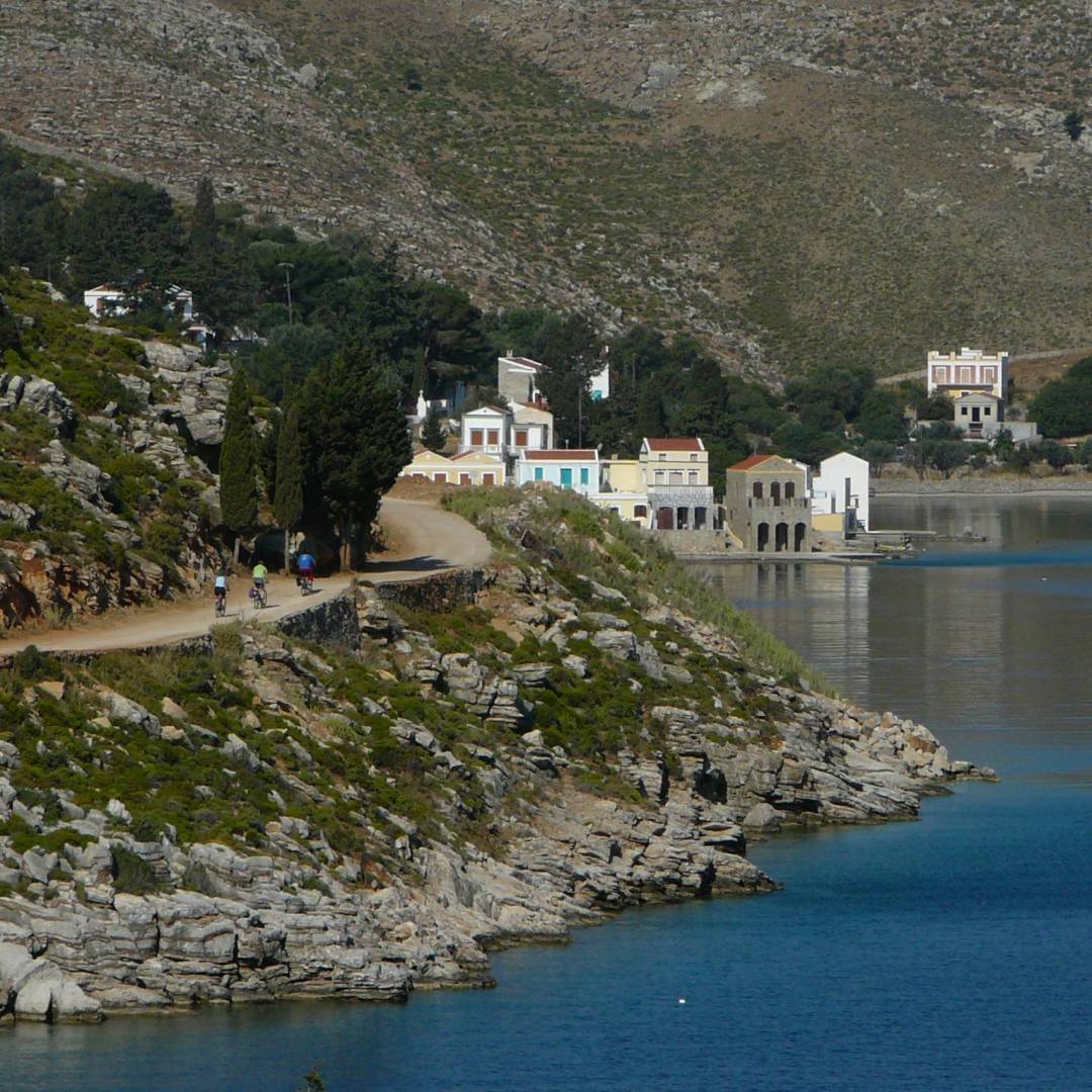 Cyclists near to the delightful town of Symi, Greece