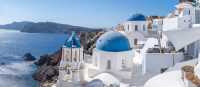 Experience the famous white-washed buildings and blue-domed churches of Santorini.