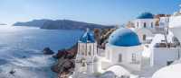 Experience the famous white-washed buildings and blue-domed churches of Santorini.