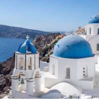 Experience the famous white-washed buildings and blue-domed churches of Santorini.