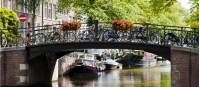 Bikes line the bridge over a canal in Amsterdam