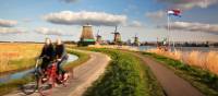 Cycling past windmills in Holland
