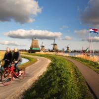 Cycling past windmills in Holland