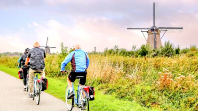 Cycling past windmills in Holland