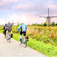 Cycling past windmills in Holland