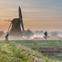 Cycling through a foggy morning in the Netherlands