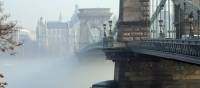 The Széchenyi Chain Bridge rises through the Autumn fog in Budapest
