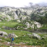 Walking past rugged mountainside on the Monte Rosa Alpine Walk