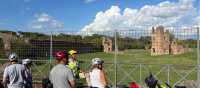Cyclists viewing the ruins of an ancient villa on the Appian Way | Kate Baker