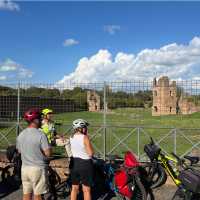 Cyclists viewing the ruins of an ancient villa on the Appian Way | Kate Baker