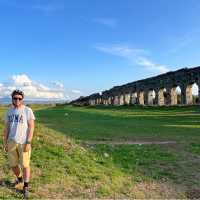 cyclist taking in the expanse of the Roman Aqueduct system | Kate Baker