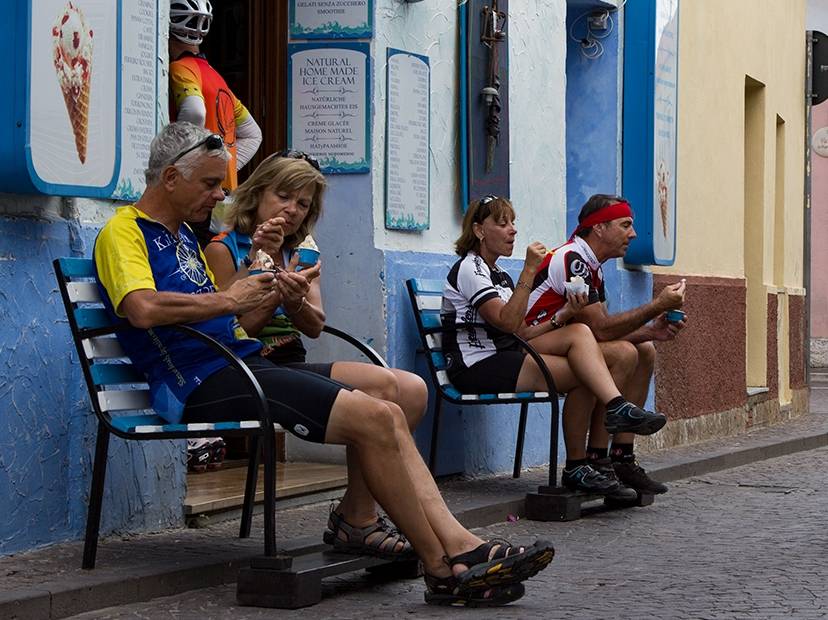 Group of cyclists taking a break at a gelateria