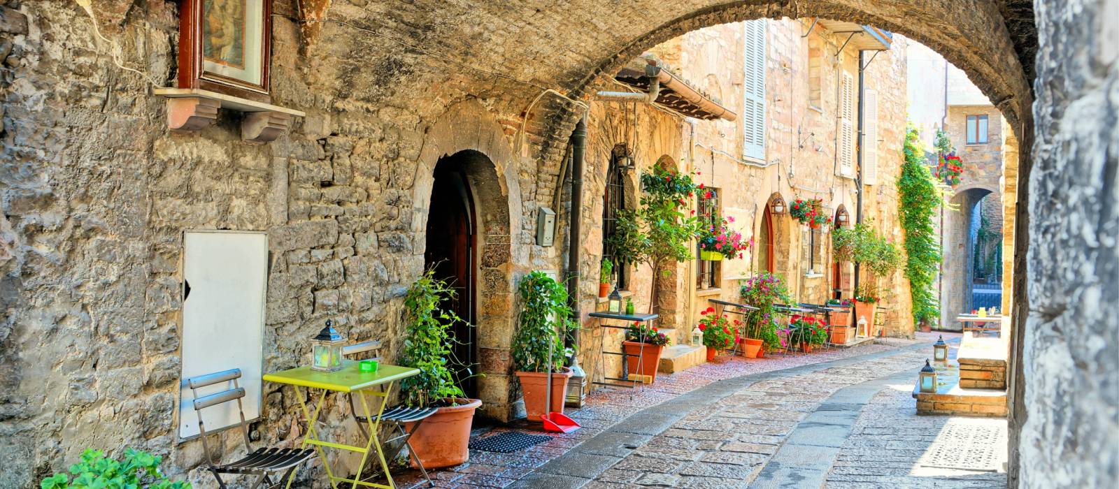 Charming arched street in the medieval town of Assisi