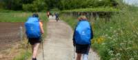 Cyclist passing pilgrims on the trail to Santiago in Portugal | Pat Rochon