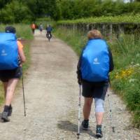 Cyclist passing pilgrims on the trail to Santiago in Portugal | Pat Rochon