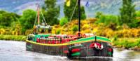 The comfortable floating hotel barge, Fingal, approaching Inverness