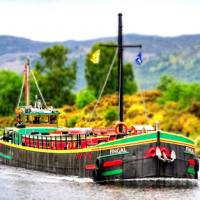 The comfortable floating hotel barge, Fingal, approaching Inverness