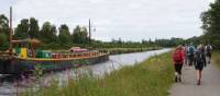 Walkers on the towpath to Inverness with the comfortable barge Fingal